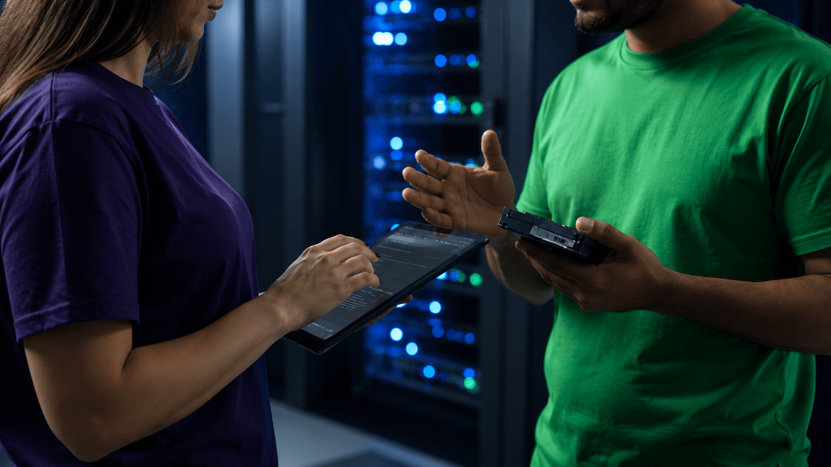 Two Divine Greentech technicians reviewing a recovered drive against a tablet asset record